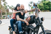 Mature hipster couple astride motorcycle, Valencia, Spain — Stock Photo