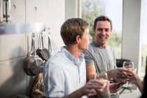 Men at party in kitchen — Stock Photo
