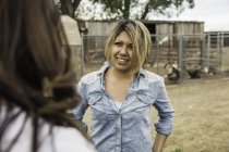 Two women on farm, in conversation — Stock Photo