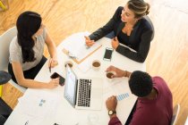 Overhead view colleges meeting at office table — Stock Photo