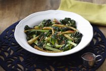 Chard and parsnip salad with pine nuts in bowl — Stock Photo