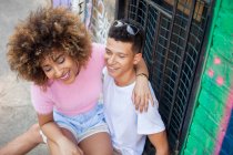 Young couple in street, fooling around, laughing — Stock Photo
