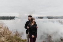 Casal jovem pela nuvem de fumaça olhando para longe, Ottawa, Canadá — Fotografia de Stock