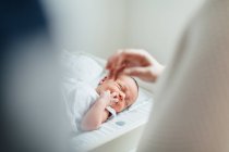 Mother and father looking at newborn baby, focus on baby — Stock Photo