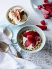 Натюрморт орехового мюсли и йогурта в мисках со свежими фруктами, вид сверху — стоковое фото