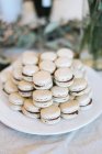 Close up of macarons stack on white plate, selective focus — Stock Photo