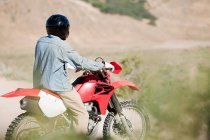 Man on riding on red dirt bike — Stock Photo
