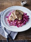 Grilled pork on braised red cabbage, close-up — Stock Photo