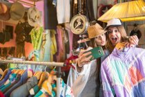 Friends taking selfie in thrift store — Stock Photo