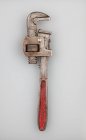 Overhead view of pipe wrench on grey background — Stock Photo
