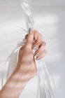Cropped view of woman hand holding ribbons — Stock Photo