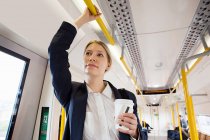 Businesswoman travelling on London Overground train — Stock Photo