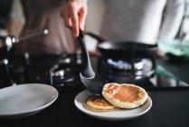 Cropped view of couple serving pancakes — Stock Photo