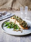 Salmon with horseradish crust, on green beans, close-up — Stock Photo