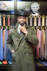 Male customer wearing in trilby in tailors shop — Stock Photo