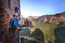 Portrait of two rock climbers on portaledge, Liming, Yunnan Province, China — Stock Photo