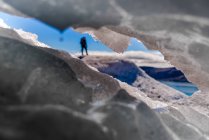 Guide seen through hole in ice on glacier in South Green — Stock Photo