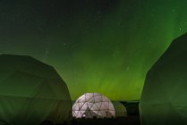 Lit up dome tent, Aurora Borealis in background, Narsaq, Vestgronland, Greenland — Stock Photo