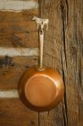 Copper pan hanging up, close up — Stock Photo