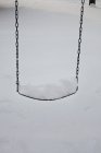 View of snow covered swing, close-up — Stock Photo