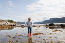 Boy with message in a bottle, Aure, More og Romsdal, Norway — Stock Photo