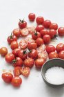 Cherry tomatoes with seasoning on a baking paper, close-up view — Stock Photo