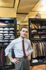 Portrait of tailor with hands on hips in tailor shop — Stock Photo