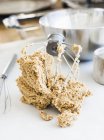 Whisk with dough on white tabletop in kitchen — Stock Photo