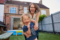 Mother and toddler daughter playing in garden, portrait — Stock Photo