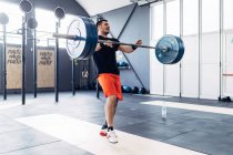 Man weightlifting barbell in gym — Stock Photo