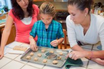 Mother and daughters baking cookies — Stock Photo