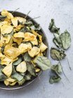 Rose petals and dry leaves in bowl — Stock Photo