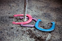 Close-up view of colorful horseshoes on ground, Horseshoes game concept — Stock Photo