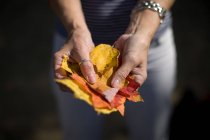 Close up of woman holding autumn leaves — Stock Photo