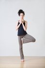Donna in posizione yoga tree durante lo yoga — Foto stock