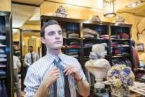 Customer trying on tie in tailors shop — Stock Photo