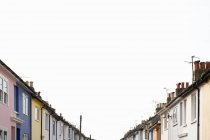 Row of colorful houses with grey cloudy sky — Stock Photo