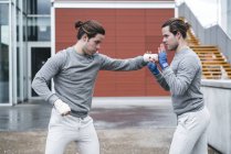 Young twin boxers training outdoors — Stock Photo