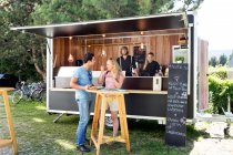 Clientes que gostam de refeições no food truck, Innsbruck Tirol, Áustria — Fotografia de Stock