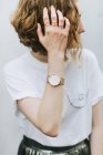 Portrait of red haired woman wearing rings and wristwatch looking away — Stock Photo