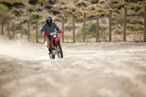 Mann fährt auf Dirt-Bike auf Wüstenpfad — Stockfoto