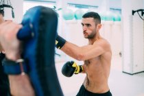 Man with personal trainer sparring in gym — Stock Photo