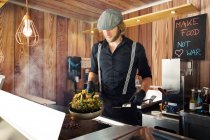 Male cook working in food truck — Stock Photo