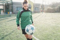 Football player practising on football pitch — Stock Photo