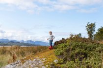 Boy playing on rock near fjord, Aure, More og Romsdal, Norway — Stock Photo