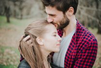 Close up of couple hugging in autumn park — Stock Photo