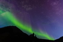 Tourists looking up at Aurora Borealis, Narsaq, Vestgronland, Greenland — Stock Photo