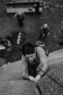 Woman trad climbing, team mates on ground, at The Chief, Squamish, Canada — Stock Photo