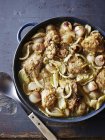 Saucepan of roasted chicken with onion and fennel — Stock Photo