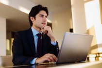 Businessman working in business centre in hotel — Stock Photo